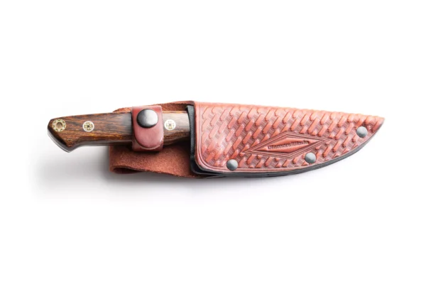 Heritage knife with polished ironwood handle secured in a tooled leather sheath by DiamondBlade