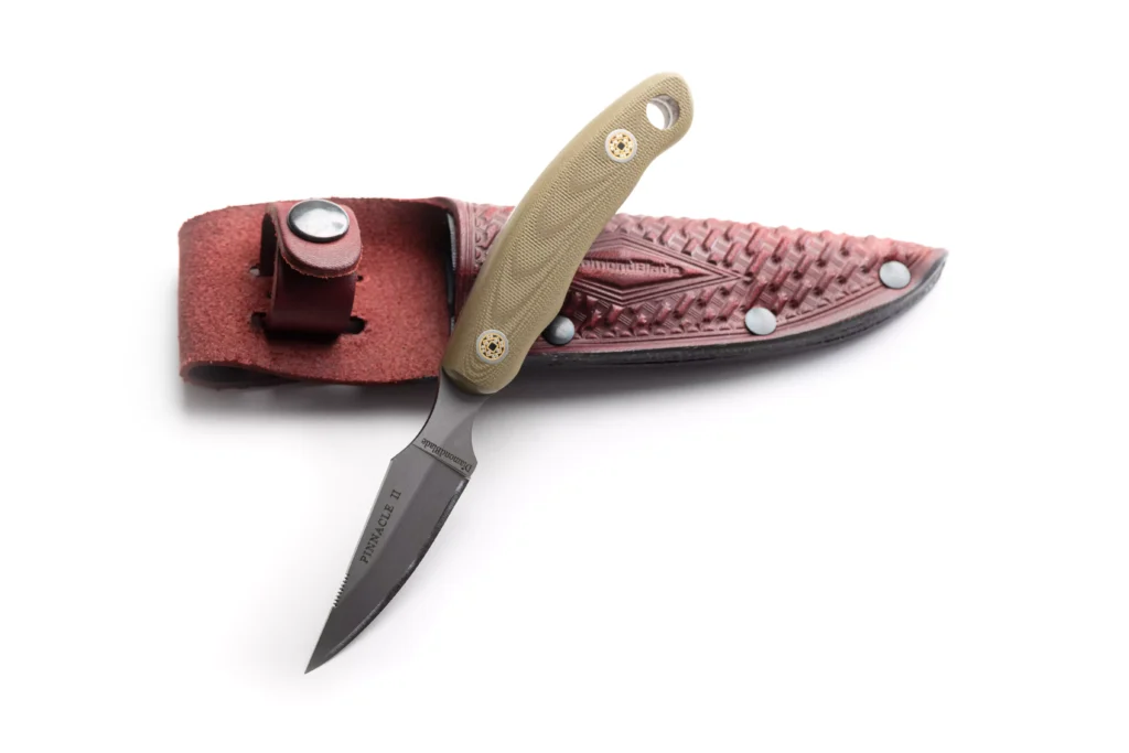 Pinnacle II knife with OD green G10 handle resting on DiamondBlade leather sheath