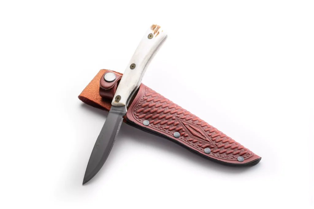 The Summit knife with stag handle resting on DiamondBlade leather sheath