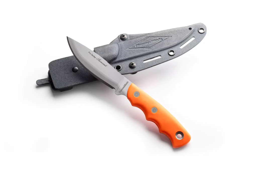 Pro Series Summit knife with orange handle resting on a black tactical sheath by DiamondBlade Knives.