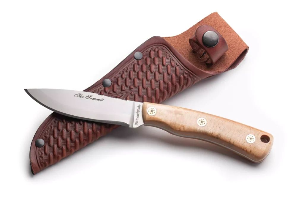 DiamondBlade Summit knife with burlwood handle resting on a leather sheath