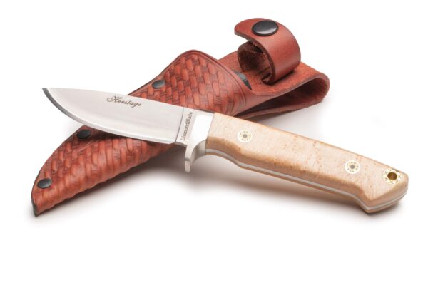 Heritage Birds Eye Maple knife with Friction Forged D2 blade and contoured G10 handle resting on a tooled leather sheath by DiamondBlade Knives